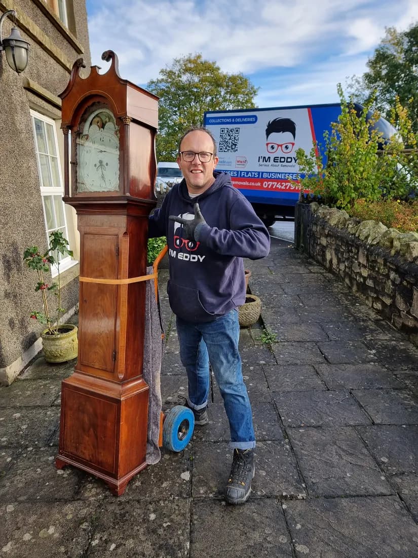 Nigel carefully moving an antique grandfather clock — single-item removals in Bristol