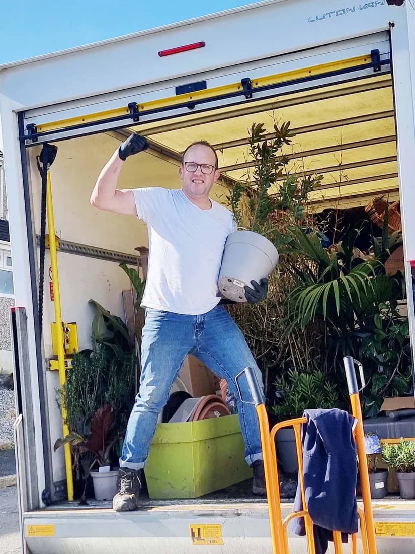 Nigel in the back of the loaded van mid-removal